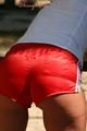 Stella posing outdoor wearing a supersexy red shiny nylon shorts and a white top (Pics)
