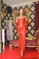 Miss Scarlett bound and gagged in a long red Latex dress