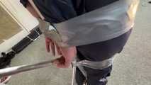 Marie taped and suspended in shiny nylon Rainwear