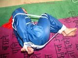 one of our archive girls tied and gagged in a shiny nylon rainsuit