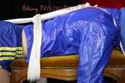 Watching sexy Sonja wearing a sexy shiny nylon shorts in blue and a blue rain jacket being tied and gagged on a stool with ropes and a clothgag (Pics)