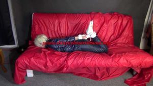 Sexy Courtney being tied and gagged on a sofa wearing sexy shiny nylon rainwear (Video)
