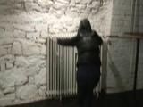 Archive girl tied, gagged and hooded in a cellar wearing a shiny black downcoat (Video)