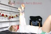 Pia tied and gagged on a bed with cuffs wearing a sexy white shiny nylon shorts and a rain jacket as well as wings (Pics)