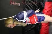 SANDRA being tied and gagged overhead with ropes and a clothgag wearing a sexy oldschool shiny nylon shorts and a rainjacket (Pics)