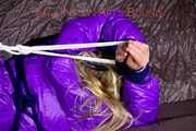 *** HOT HOT HOT*** NEW MODELL*** SANDRA wearing a sexy transparent purple shiny nylon pants and a purple down jacket tied and gagged on a sofa with ropes hand to feet and a cloth gag (Pics)