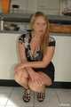 Benita opens her blouse and lifting her skirt in front of the kitchen