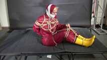 Alice bound and gagged in a nylon Rainsuit