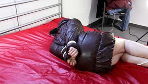 Jill tied and gagged in a shiny nylon downcoat
