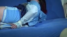 Jill tied and gagged on a blue sofa wearing a sexy lightblue shiny nylon shorts and an oldschool rainjacket (Video)