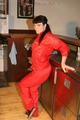 Jill posing in a bar wearing a sexy red rainwear combination with nothing under it (Pics)