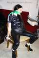 Lucy tied and gagged with rope and gag on a chair wearing a sexy black shiny nylon jumpsuit (Pics) 