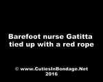Barefoot nurse Gatitta tied up with a red rope (video)