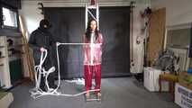 Aiyana in a shiny nylon red rainsuit and a see through PVC Rainjacket, tied gagged, hooded and vibed