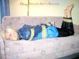 Archive girl tied and gagged with tape and rope wearing shiny nylon rainwear in blue (Pics)