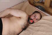 Amanda undresses and ties a man into hogtie and gag him