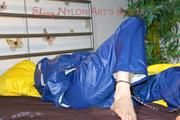 Lucy ties, gagges and hoodes herself on a bed wearing a sexy AGU rainnwear combination (Pics)