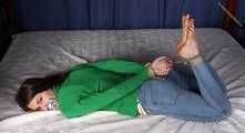Roxana hogtied on bed