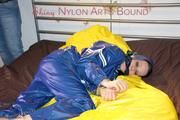Lucy ties, gagges and hoodes herself on a bed wearing a sexy AGU rainnwear combination (Pics)
