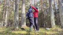 Sebastien breathplay tied up in a puffer jacket among the trees.