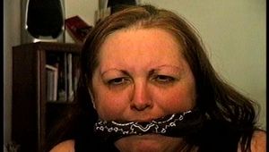 46 Yr OLD REAL ESTATE AGENT'S IS MOUTH STUFFED, HANDGAGGED, BANDANNA CLEAVE AND OTM GAGGED, ROPE GAGGED WITH HANDS TIGHTLY TIED WITH THIN RAWHIDE (D72-10)