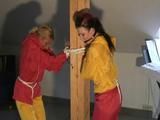 a video with two of our archive girls bound and gagged in shiny nylon rainsuits