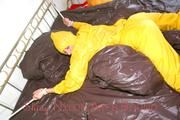 Stella tied and gagged on a bed wearing a supersexy yellow rainwear combination (Pics)