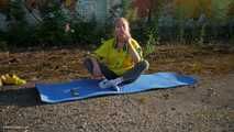 Anastasia is doing some fitness and stretching while smoking outdoors
