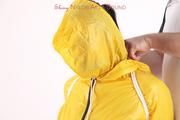 Jill tied and gagged in a shiny yellow rainsuit and rubber boots