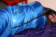 Alina tied and gagged in a shiny skisuit