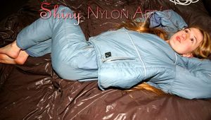 Katharina posing on a bed wearing a supersexy grey-blue downwear combination (Pics)