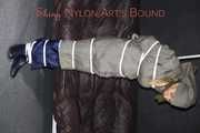 Sexy Sandra being tied and gagged overhead with ropes and a clothgag hodded wearing a sexy rainwear combination (Pics)