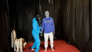 Hogtied, sweater, plastic wrap and a unbreathable hood.