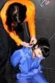 Jill bound and gagged by Simone in shiny nylon rainwear