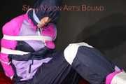 Watching Pia wearing blue/pink shiny nylon rainwear being tied and gagged and hooded with tape and a clothgag (Pics)