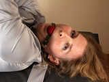 Ballgagged barefoot Albina Rose, balltied on the massage couch, wiggles helplessly