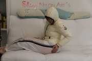 SEXY Jill wearing a WHITE rain pants and a WHITE down jacket lolling on the sofa playing with you (Pics)