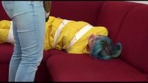Mara tied and gagged with tape on a sofa wearing a sexy shiny yellow rainwear combination (Video)