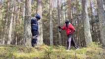 Sebastien breathplay tied up in a puffer jacket among the trees.