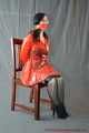 Bound in PVC minidress and red raincoat