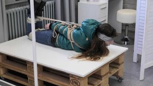 Poor Rey got catched by a mean couple which heavily tied and gagged her in her new shiny Down jacket. They stored her on a rolling table and gave her some bad news before Rey got tickeled, laughing in her pantygag.