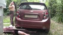 Mistress Jenna stands on the slave with a car while smoking in the slave's mouth B