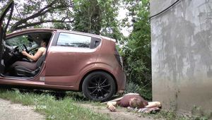 Mistress Jenna stands on the slave with a car while smoking in the slave's mouth B