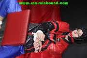 Sexy PIA wearing a sexy blue rainbib and a black/red shiny nylon rainjacket being tied, gagged and hooded on a chair with ropes and a ballgag (Pics)