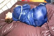 Stella tied and gagged in shiny nylon rainwear