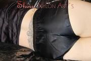 Mara wearing a supersexy black shiny nylon shorts and a super short belly rain jacket lolling on a white sofa (Pics)