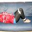 Jill tied, gagged and hooded on the sofa wearing a sexy black shiny nylon pants and two rain jackets (Pics)