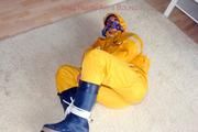 Katharina tied and gagged in a yellow rainsuit