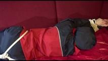 Lucy tied, gagged and hooded on a sofa wearing an oldschool rainwear combination (Video)