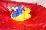 Sonja tied, gagged and hooded on a sofa wearing a sexy blue rain pants and a yellow downwear jacket (Pics)